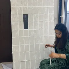 Working on a large gridded piece, carefully masking out the lines with tape. It's a meticulous process, but the clean, geometric result is always worth it.