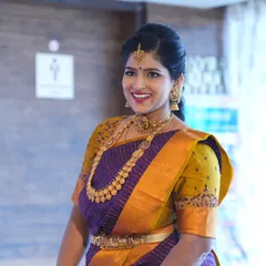 The perfect glow for a son's naming ceremony. This client looks radiant in her traditional purple and yellow saree. The makeup is kept classic and elegant to complement her beautiful temple jewellery.