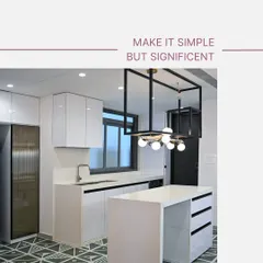 Simplicity can make a significant impact. This minimalist kitchen features all-white handle-less cabinets, a sleek island that doubles as a breakfast counter, and a striking geometric tile floor. The industrial-style pendant light adds a modern, artistic touch.