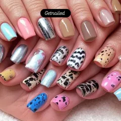Our courses cover a wide variety of nail art styles. Here you can see a sampler of techniques we teach, including animal prints, chrome effects, and solid color application, ensuring you can cater to any client request.