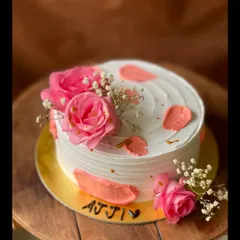 A lovely cake for 'Ajji' (grandmother), decorated with fresh pink roses, baby's breath, and delicate strokes of pink buttercream.