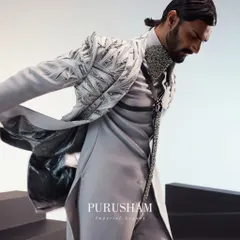 The movement of this grey jacket shows off its unique construction and the contrasting lining. It is a piece designed to be dynamic and visually interesting from every angle.