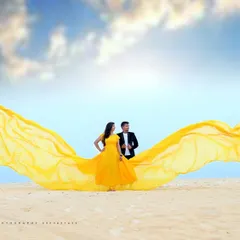 Our flying gowns are perfect for creating breathtaking photos. This vibrant yellow gown looks spectacular against the open sky and beach, and the long, flowing fabric creates a magical effect in your pre-wedding or maternity pictures.