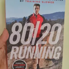 This book, '80/20 Running', is a cornerstone of my coaching philosophy. I believe that most of your weekly mileage should be at a low to moderate intensity, which builds a powerful aerobic engine and reduces the risk of burnout and injury.