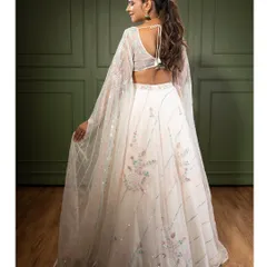 A view of the back of the white embroidered lehenga, showing the beautiful sleeve details and the delicate tie-up back. Every angle is designed to be picture-perfect.