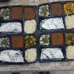 A simple and satisfying meal for four people. These thalis feature a paneer dish, a homely dal, rice, and rotis. Perfect for a small family lunch or dinner.