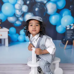 This two-year-old is looking sharp in his striped suit and bow tie, ready for his vintage-themed birthday photoshoot.