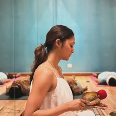 Holding a Tibetan singing bowl, I prepare to begin a sound bath. The pure, resonant tones of the bowl are used to calm the nervous system and guide the mind into a meditative state.