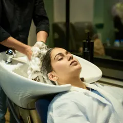 A moment of pure bliss during a hair wash and treatment. I believe in providing a serene and comfortable experience for every client.