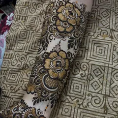 A close-up of a single arm, showcasing the bold rose motifs and delicate leaf fillers. This is a classic floral look.