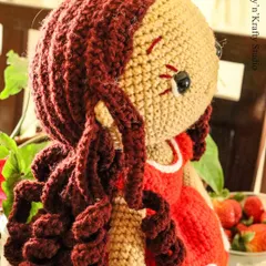A side view of Lily, showing the detail in her bouncy, individually stitched brown curls. It took two full days to create her hair, and I think it gives her so much personality.