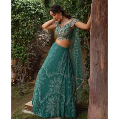 The flowy silhouette of this teal green lehenga makes it comfortable to wear while still looking incredibly elegant. The intricate beadwork on the blouse is a key feature.