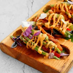 A fusion of Japanese and Mexican cuisine. Our crispy sushi tacos feature a crunchy shell filled with seasoned rice and fresh vegetables, drizzled with a tangy sauce for a truly unique appetiser.