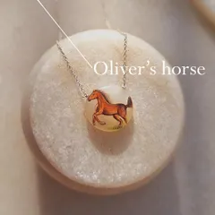 The "Oliver's Horse" pendant, a unique hand-painted talisman for emotional stability.