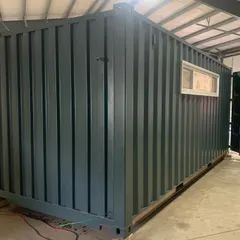 The exterior of the 20-foot music studio container during the build phase. Even at this early stage, you can see how the placement of windows begins to define the character of the final structure.