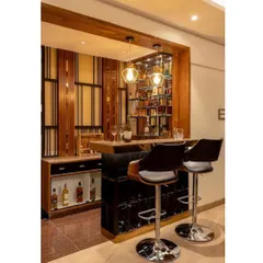 A sophisticated home bar designed for the modern connoisseur. The design features a dark wood and black color scheme, ample bottle storage, and comfortable bar stools for entertaining.