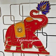 A beautiful handcrafted elephant wall hanging, perfect for adding a touch of tradition and blessing to a new home during a housewarming ceremony.