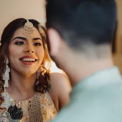A sweet, candid moment where the bride looks at her groom with a beautiful, genuine smile. These are the quiet, in-between moments that tell the real story.