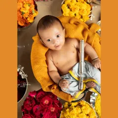 Happy Krishna Janmashtami! This festive setup with a baby as little Krishna, surrounded by colorful flowers and holding a flute, is a beautiful way to celebrate and create a unique memory.