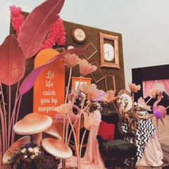Let's go down the rabbit hole. This whimsical 'Alice in Wonderland' themed photo booth was a highlight, featuring oversized mushrooms, vintage clocks, quirky furniture, and a custom sign, making for a fun and interactive corner.