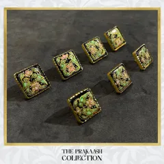 Our handmade metal buttons offer a unique upgrade for any garment. This set of square buttons features intricate floral meenakari work in pastel pink and green on a black enamel base, perfect for adding a touch of artistry to a blazer or kurta.