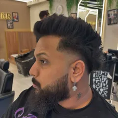 A side profile of a modern mullet with a clean fade, showcasing the detailed work that goes into every men's cut.