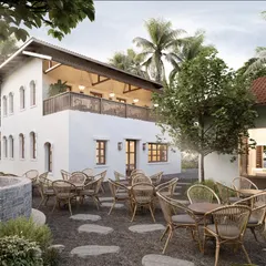 The outdoor seating area is designed to feel like a natural extension of the landscape. Using simple wicker furniture and flagstone paths, we created a relaxed ambiance where guests can enjoy the open air under the shade of palm trees.