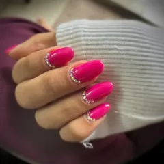 This beautiful fuchsia gel manicure with a delicate rhinestone cuticle accent was done by one of my students. It shows mastery of shaping, color application, and embellishment.