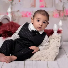 This photo showcases the baby's curious gaze. The soft, neutral background keeps the focus entirely on the baby and his adorable features.