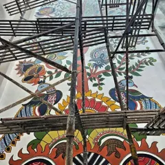 The base of the Kalamkari mural, where peacocks stand guard. This traditional Indian folk art style, usually seen on fabric, finds a new, permanent home on this wall.