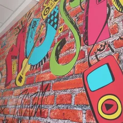 The vibrant graffiti wall at our music school. It's a space designed to inspire creativity from the moment you walk in.