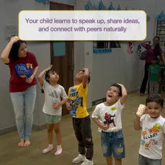 In our group activities, your child learns to speak up, share ideas, and connect with peers naturally. An instructor leads a game where children are encouraged to participate, fostering a comfortable environment for communication.