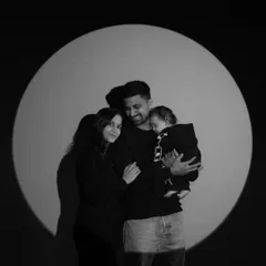 The same modern family portrait, presented in timeless black and white. This version emphasizes the emotion and connection within the family, creating a powerful and artistic image.