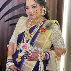 This mom-to-be looks radiant in a custom pink and white floral jewellery set for her Dohale Jevan. The design includes a maang tikka, earrings, necklace, kamarband, and bajuband, with a special 'Aai' brooch.