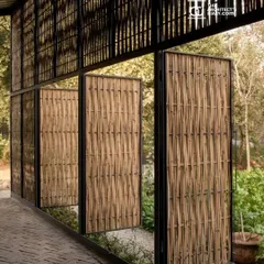 Pivoting bamboo-clad doors at the Artist Residency open up to the garden. These custom fixtures allow the inhabitants to control the level of openness and porosity, transforming the boundary between the interior studio and the exterior landscape.