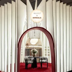 The entrance to the sanctuary. The deep red archway provides a dramatic contrast to the soft, white fabric structure, creating an inviting portal that draws you into the serene world within.