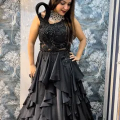 This unique black tiered gown is a showstopper for any evening event. I've paired it with a bold, modern choker to create a high-fashion look, all available for rent.