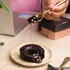 Capturing the perfect "money shot" of a molten chocolate lava cake, with the gooey center dripping onto the plate.