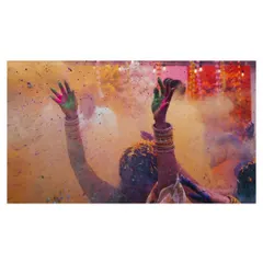 This image is pure celebration. The hands raised in the air, covered in the bright powders of the festival, symbolize the collective joy and vibrant spirit of the wedding festivities.