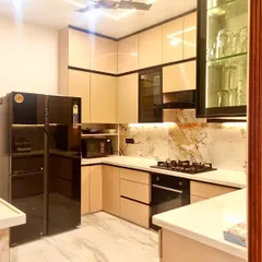 A kitchen should be as beautiful as it is functional. For this open-plan kitchen renovation, I used sleek, high-gloss cabinetry, integrated appliances, and dramatic under-cabinet lighting to highlight the beautiful marble backsplash, creating a space that’s perfect for both cooking and socializing.