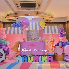 A full stage setup for Naomika's Candyland party. This sweet dream is filled with giant donuts, lollipops, ice cream cones, and a candy shop backdrop, all in a delightful pastel color scheme.