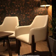 A pair of my custom dining armchairs, crafted from premium quality wood for lasting durability. Their versatile design makes them suitable for both dining and as accent seating.