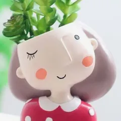Another one of my adorable character planters, this one with a winking expression and a polka-dot dress. These small pots are perfect for bringing a little bit of joy and green to a small space like a windowsill or work desk.