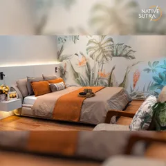 This eco-chic master bedroom brings the tranquility of nature indoors with a stunning botanical feature wall. The design balances minimalist pearl white and oak tones with warm, layered textiles, creating a modern and serene oasis that appeals to contemporary tastes.