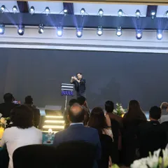 A view from the audience during one of my mentalism routines. I design my acts to be engaging and mystifying, ensuring everyone in the room is captivated by the performance.