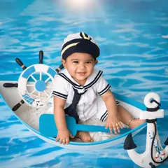 All aboard for a fun sailor-themed shoot! Dressed in a classic sailor outfit, this little captain is all smiles while navigating the high seas in my custom boat prop.
