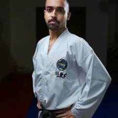 A portrait in my dobok. The uniform represents a commitment to continuous learning and upholding the tenets of Taekwon-Do: courtesy, integrity, perseverance, self-control, and indomitable spirit.