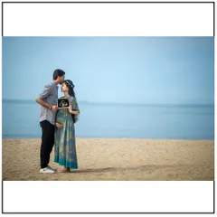 A beautiful maternity shoot on a Mumbai beach. The open sky and calm water provide a serene and timeless backdrop for this couple's portrait with their sonogram.