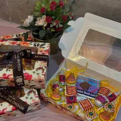 A closer look at my edible firecracker chocolate box for Diwali. The box is filled with chocolates shaped like popular firecrackers and tied with my branded ribbon.