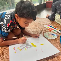 The process is just as important as the result. Here, a young artist is carefully painting his version of Sonic the Hedgehog, learning about shapes, lines, and colors as he goes.